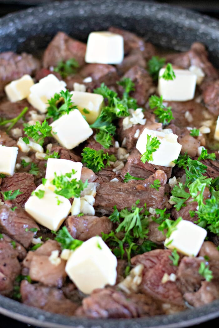 Cubes of butter and parsley on steak bites