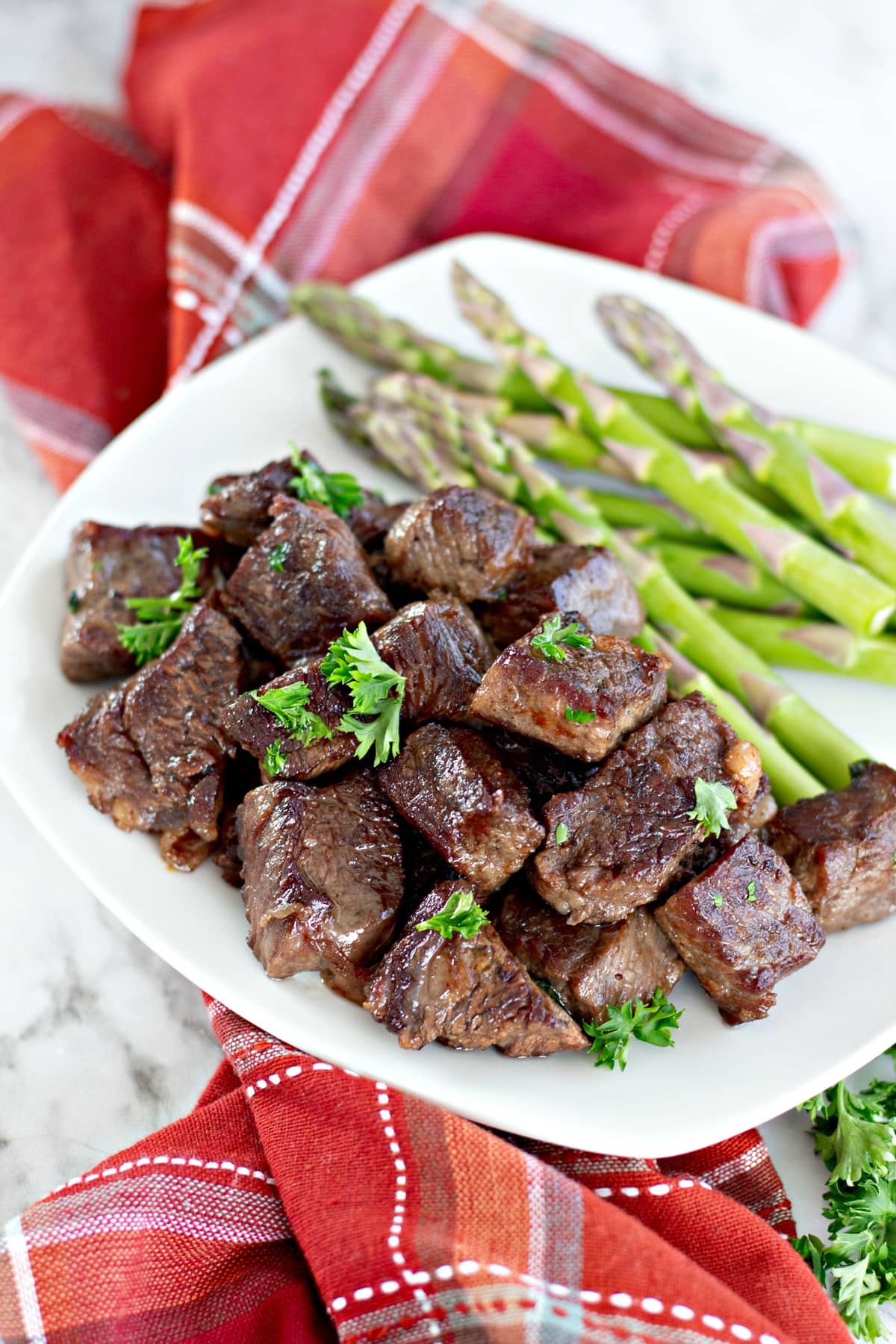 Easy steak bites on a plate with asparagus