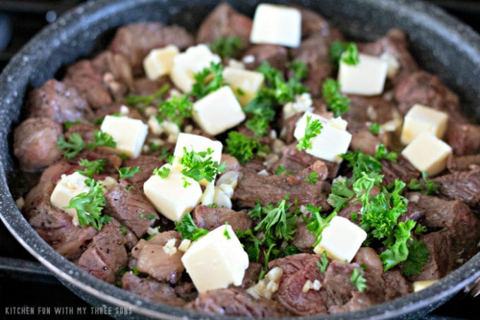 Fresh parsley and butter in a pan with meat