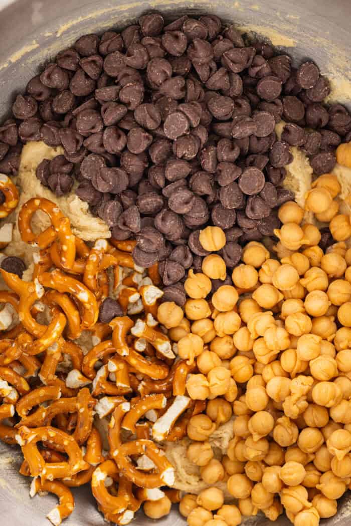 Made with brown butter, pretzels, caramel bits, and chocolate chips, Kitchen Sink Cookies are the perfect combination of sweet and salty. Pretzels, caramel bits, and chocolate chips added to cookie dough
