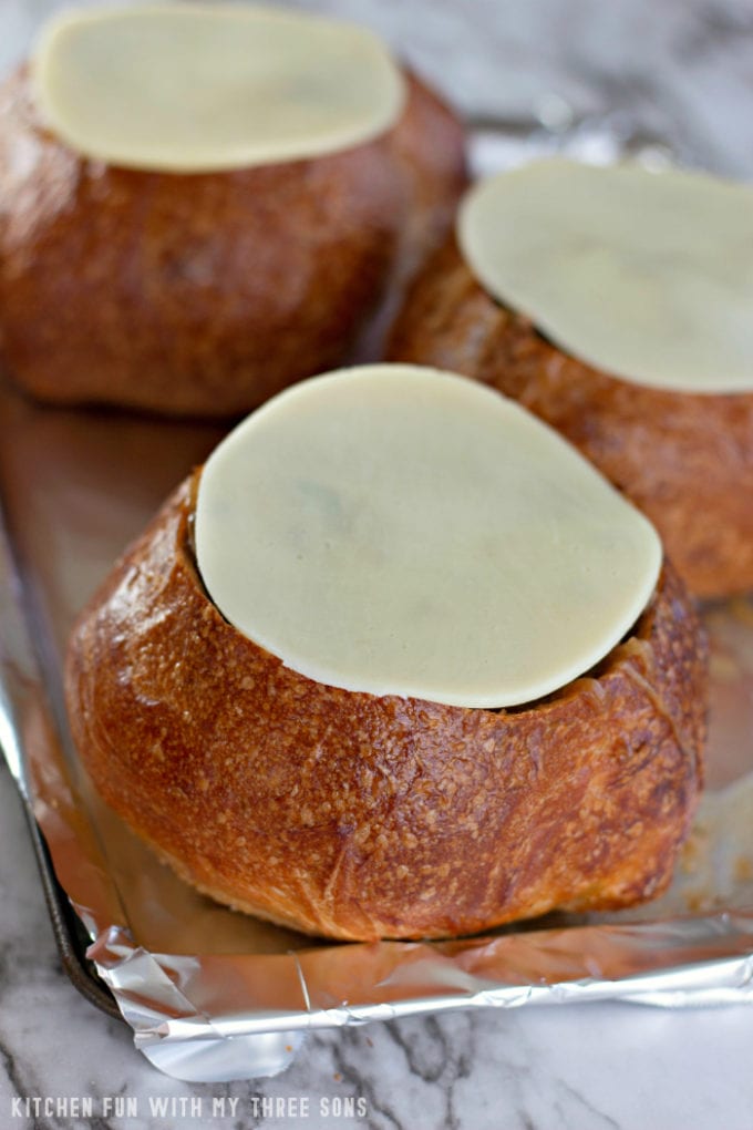 provolone cheese slices on top of bread bowls