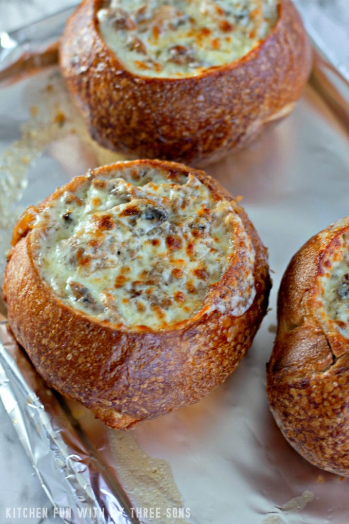 broiling cheese on top of bread bowls on a foil lined pan