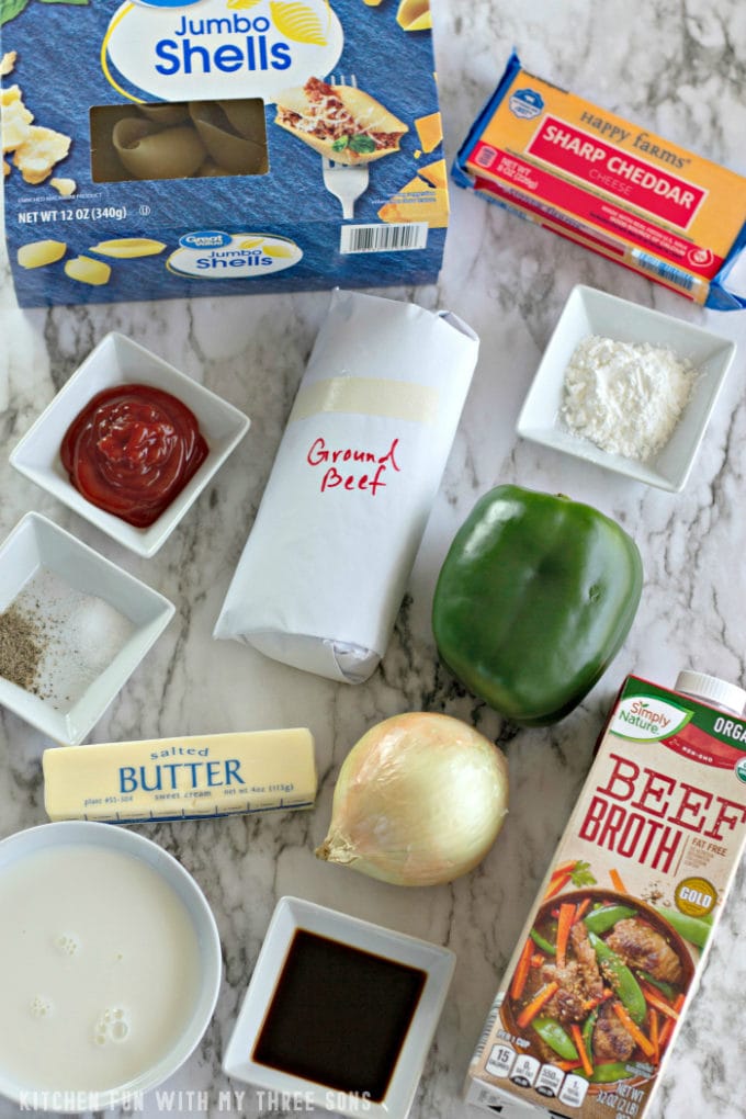 ingredients to make stuffed shells on a marble countertop