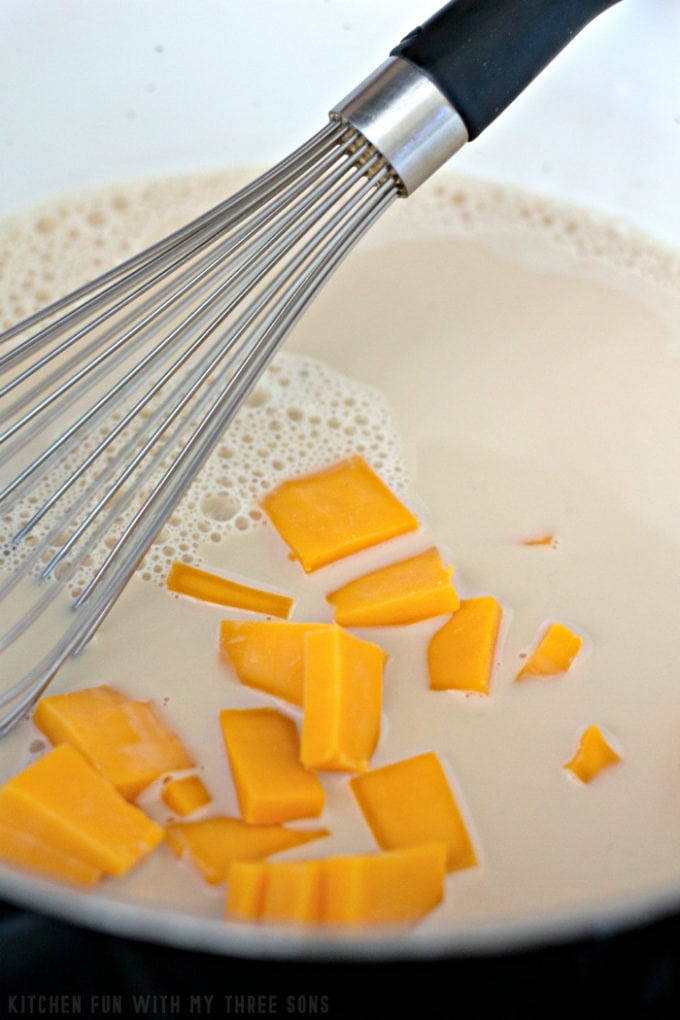 whisking together ingredients for homemade cheese sauce