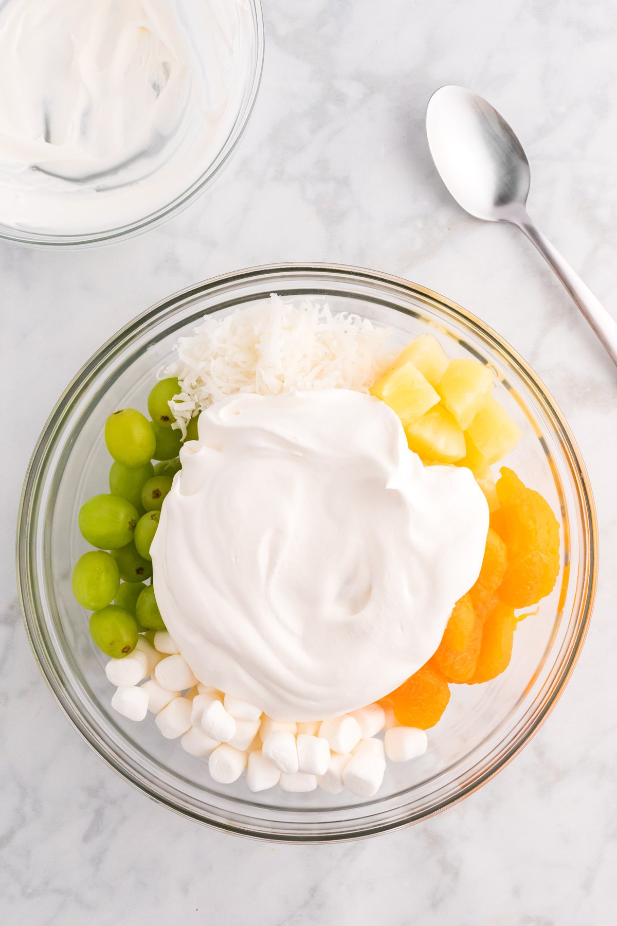 Fruit topped with whipped topping in a bowl