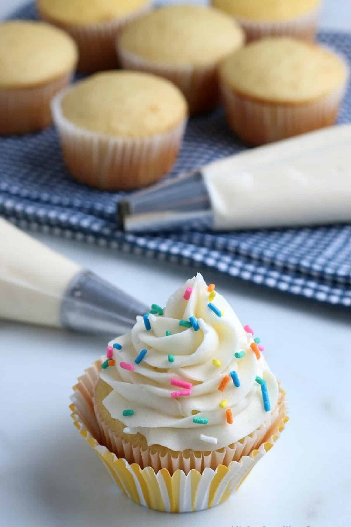Thick and creamy with a delightfully tangy flavor, this Cream Cheese Frosting recipe requires just 4 basic ingredients and 15 minutes. Cream Cheese Frosting on top of a cupcakes with sprinkles