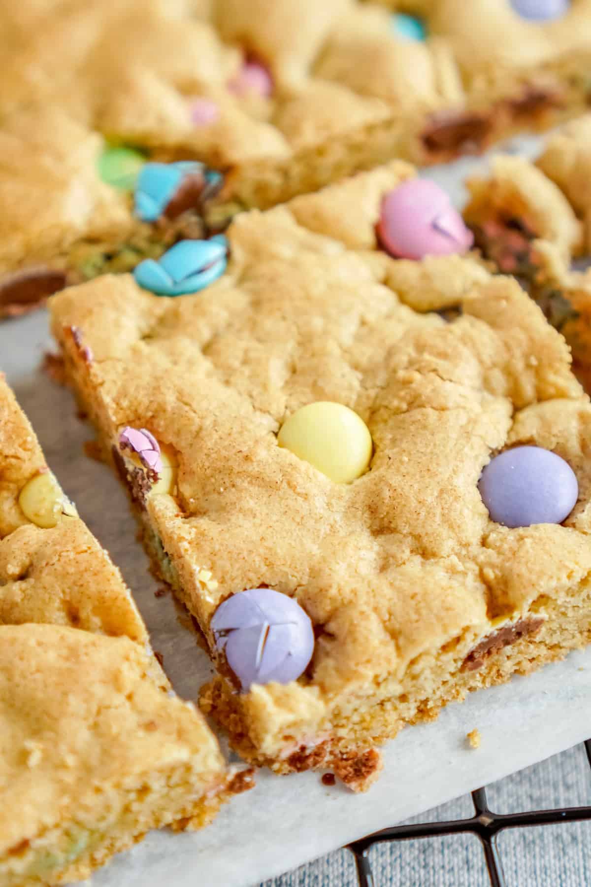 These soft and chewy Easter Cookie Bars are loaded with pastel chocolate M&M’s and so pretty for any Easter gathering. top view of Easter cookie bars cut into squares