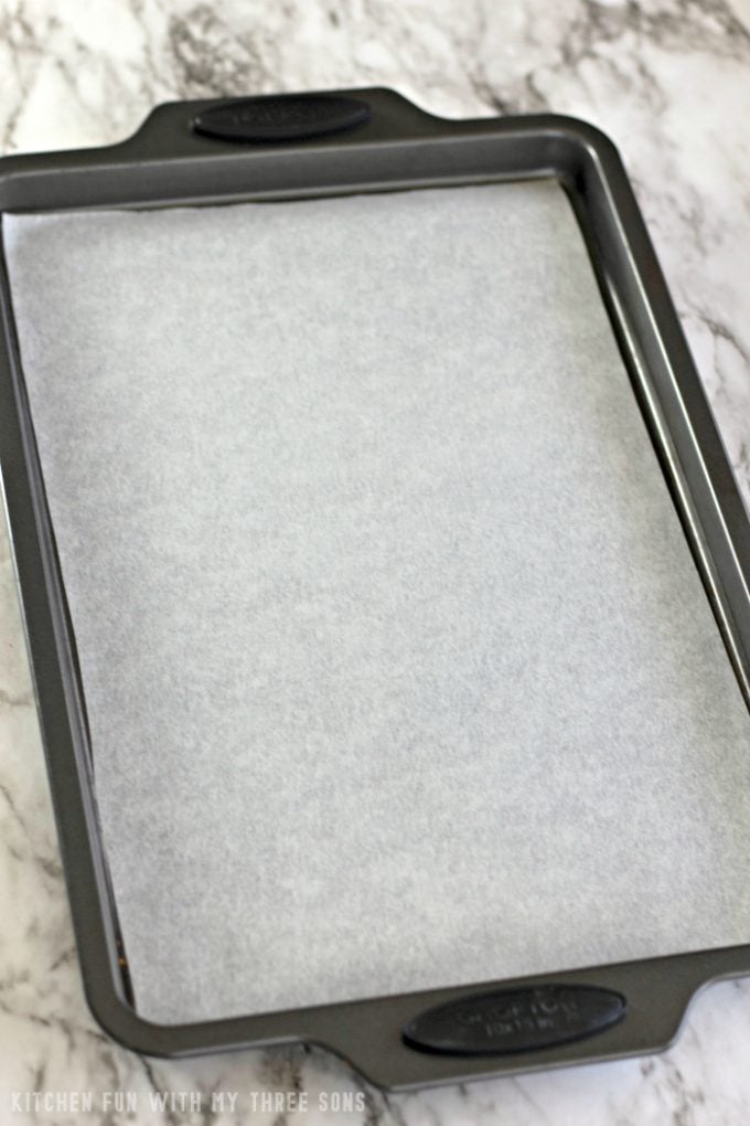 preparing a sheet pan with parchment paper