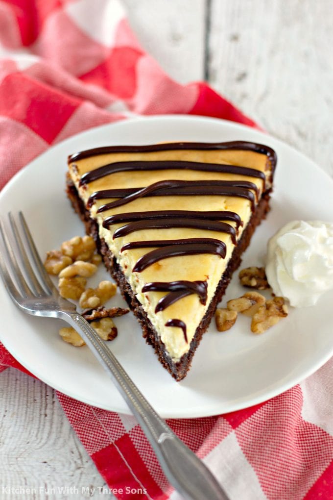 a slice of Brownie Bottom Cheesecake on a white plate