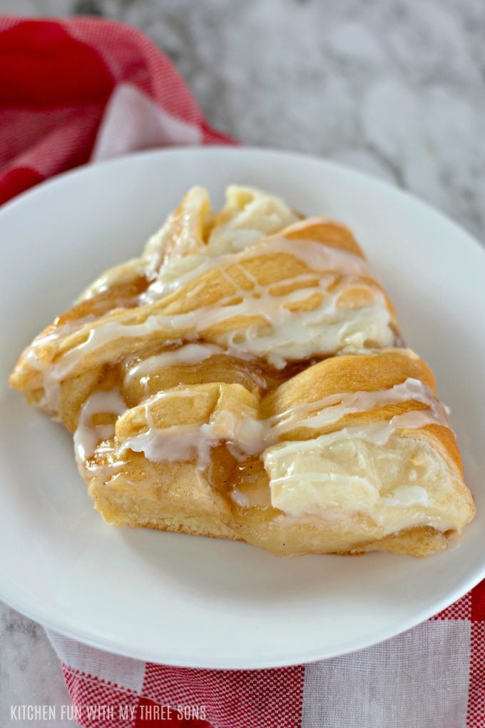 a slice of apple pie danish on a white plate