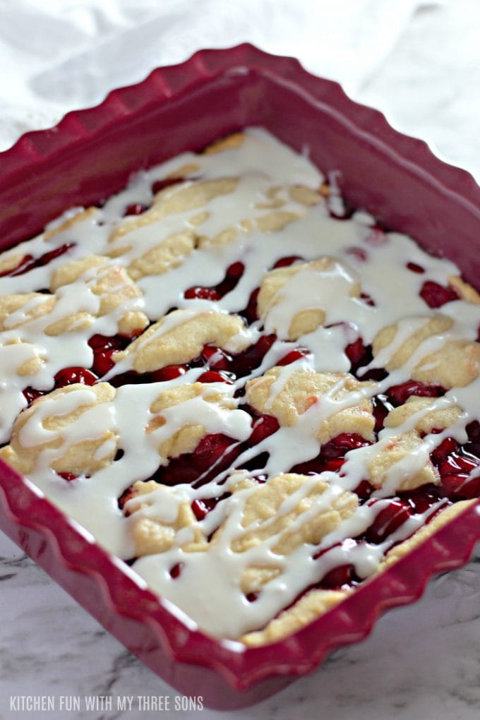 Easy Cherry Pie Bars in a burgundy square baking dish