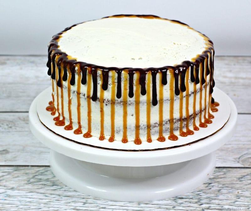 white cake with chocolate and caramel dripping on the sides