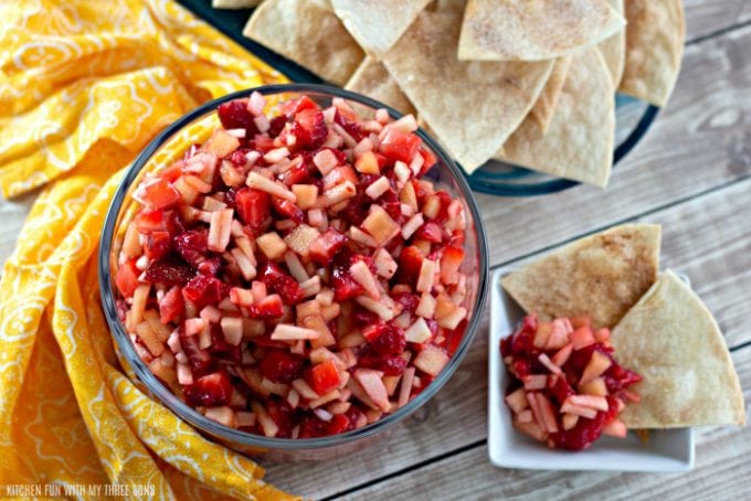 Fruit Salsa with Cinnamon Tortilla Chips with a yellow napkin on a wood table