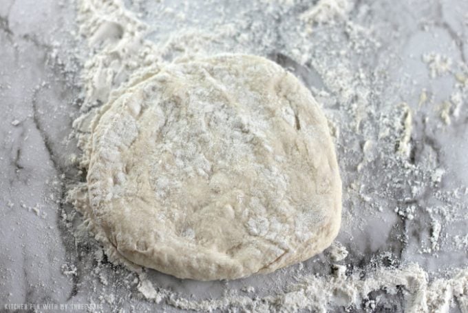 shaping dough to make fry bread on a flour dusted marble counter