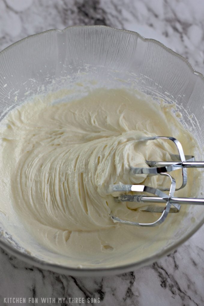 beating cream cheese and sugar together with an electric mixer