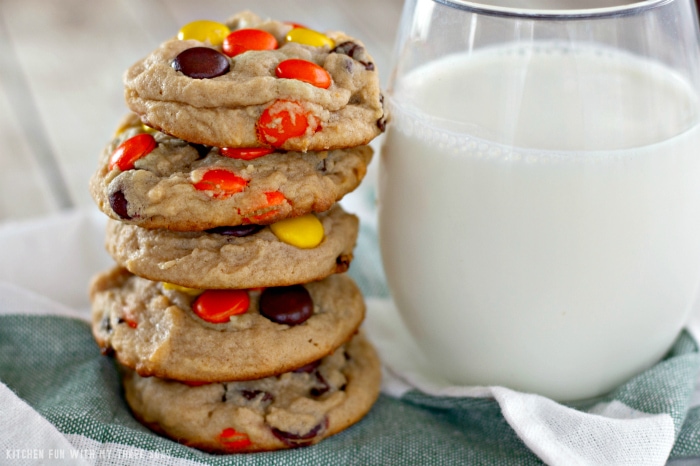 A stack of Reese's peanut butter cookies next to a glass of milk.