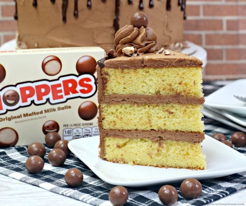 butter cake with chocolate frosting and whoppers on a white plate