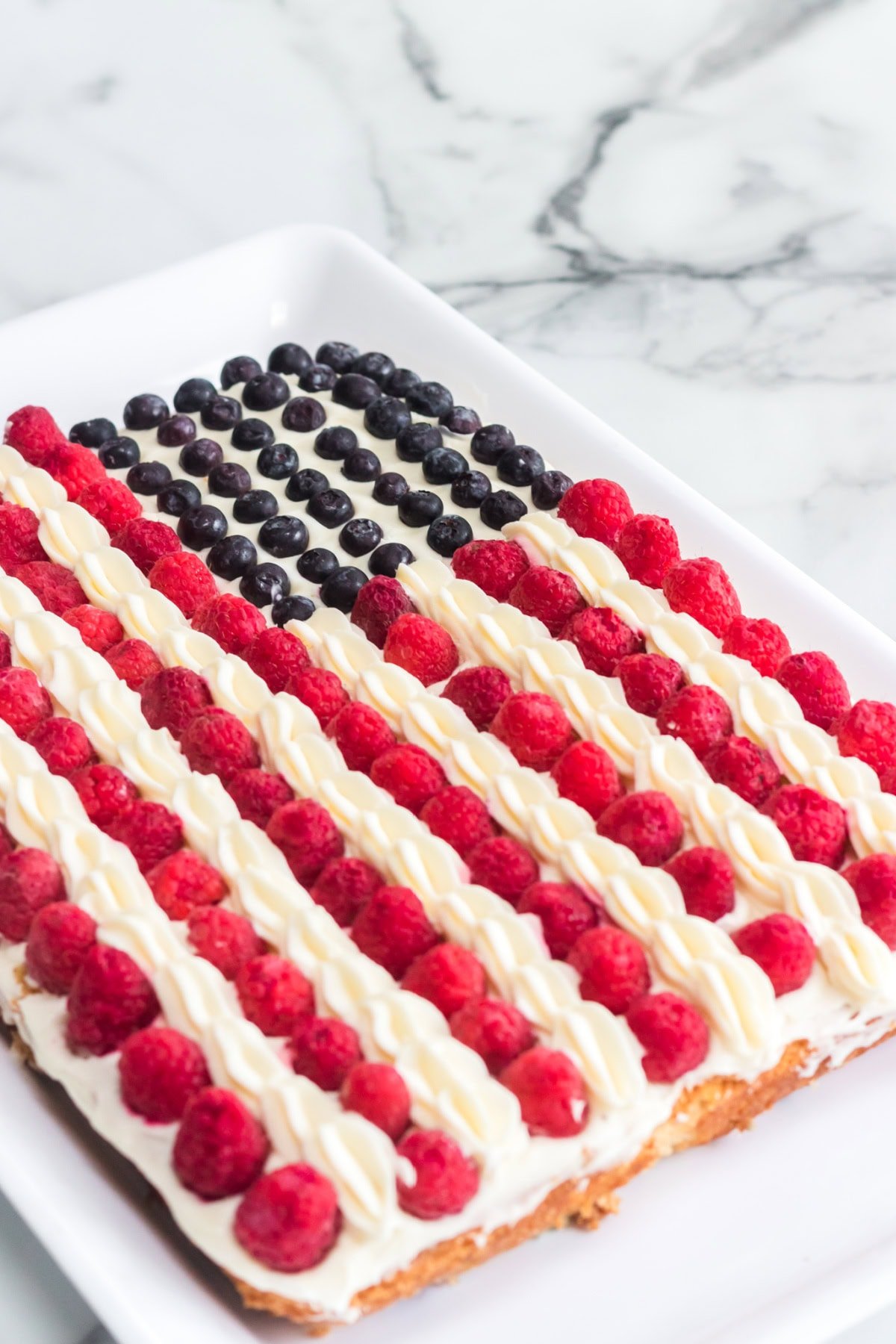 This American Flag Cake Recipe is easy to make and perfect for Memorial Day or 4th of July. American Flag Cake decorated with berries