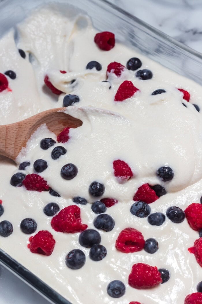 This American Flag Cake Recipe is easy to make and perfect for Memorial Day or 4th of July. mixing the berries into the cake batter