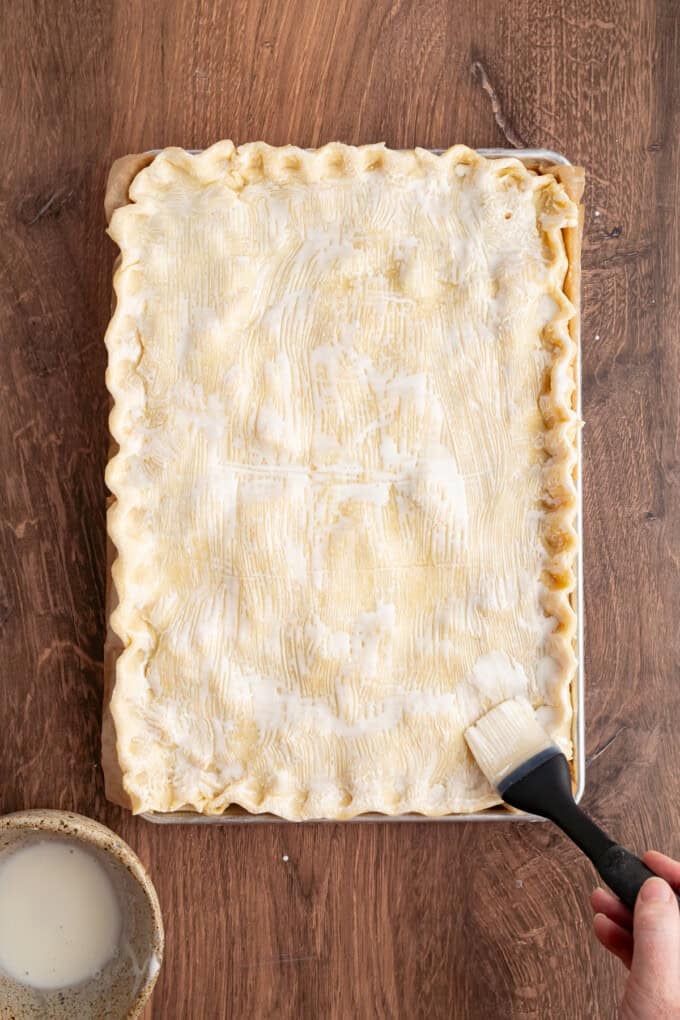 With a flaky, buttery crust and perfectly spiced apple filling baked in a jelly roll pan, Apple Slab Pie is ideal for holidays and gatherings. An unbaked apple slab pie
