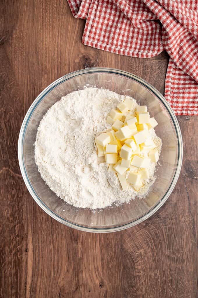With a flaky, buttery crust and perfectly spiced apple filling baked in a jelly roll pan, Apple Slab Pie is ideal for holidays and gatherings. Flour and cubed butter in a bowl