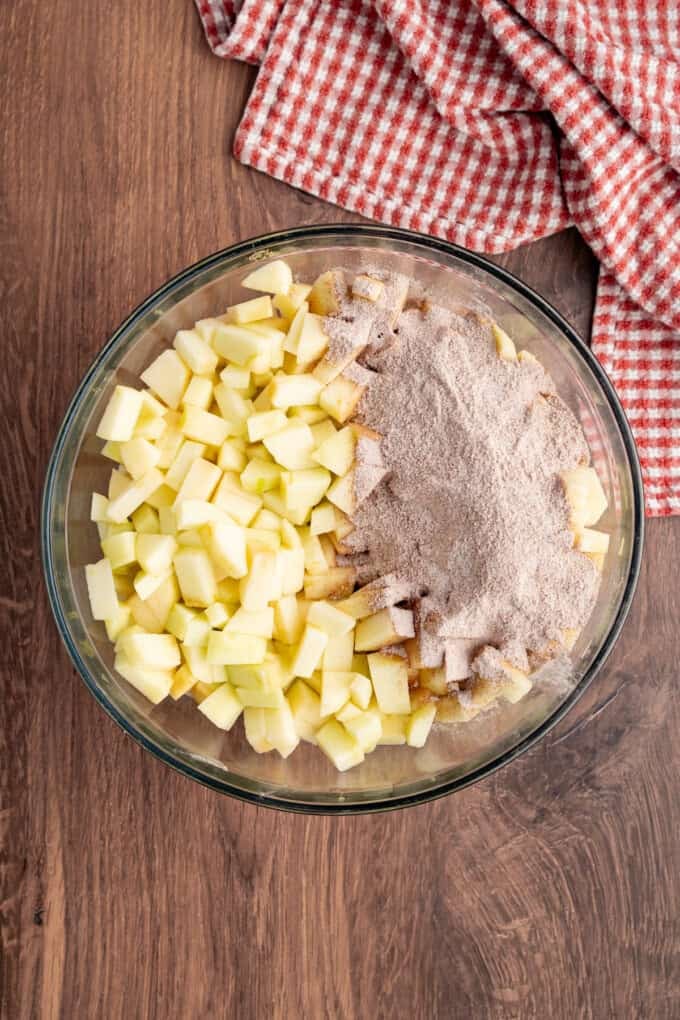 With a flaky, buttery crust and perfectly spiced apple filling baked in a jelly roll pan, Apple Slab Pie is ideal for holidays and gatherings. Diced apples and spices in a bowl