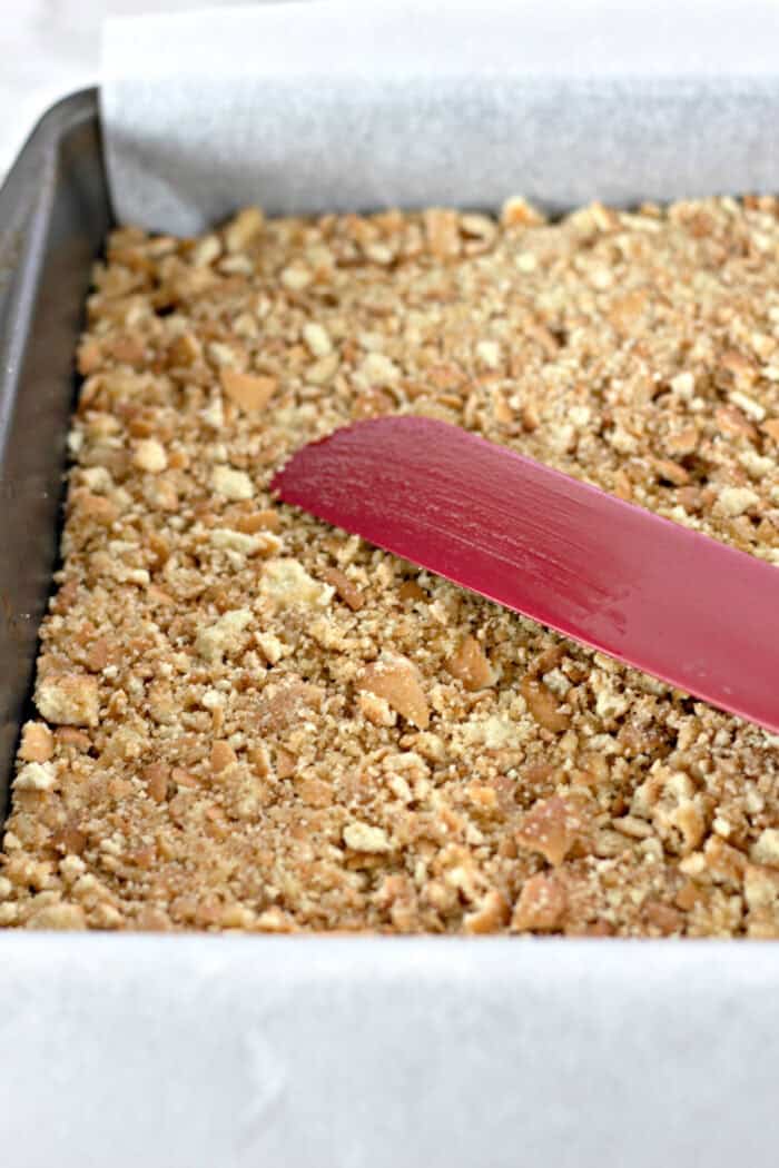pressing the vanilla wafer crust into pan