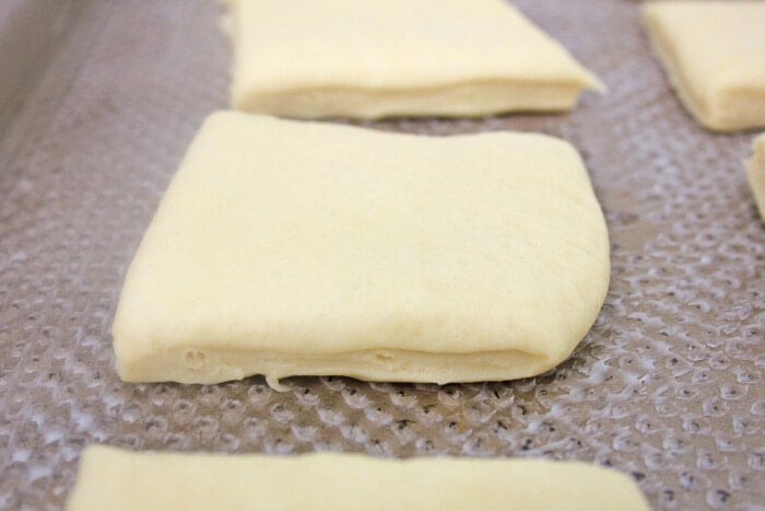 dough for rolls on a baking sheet