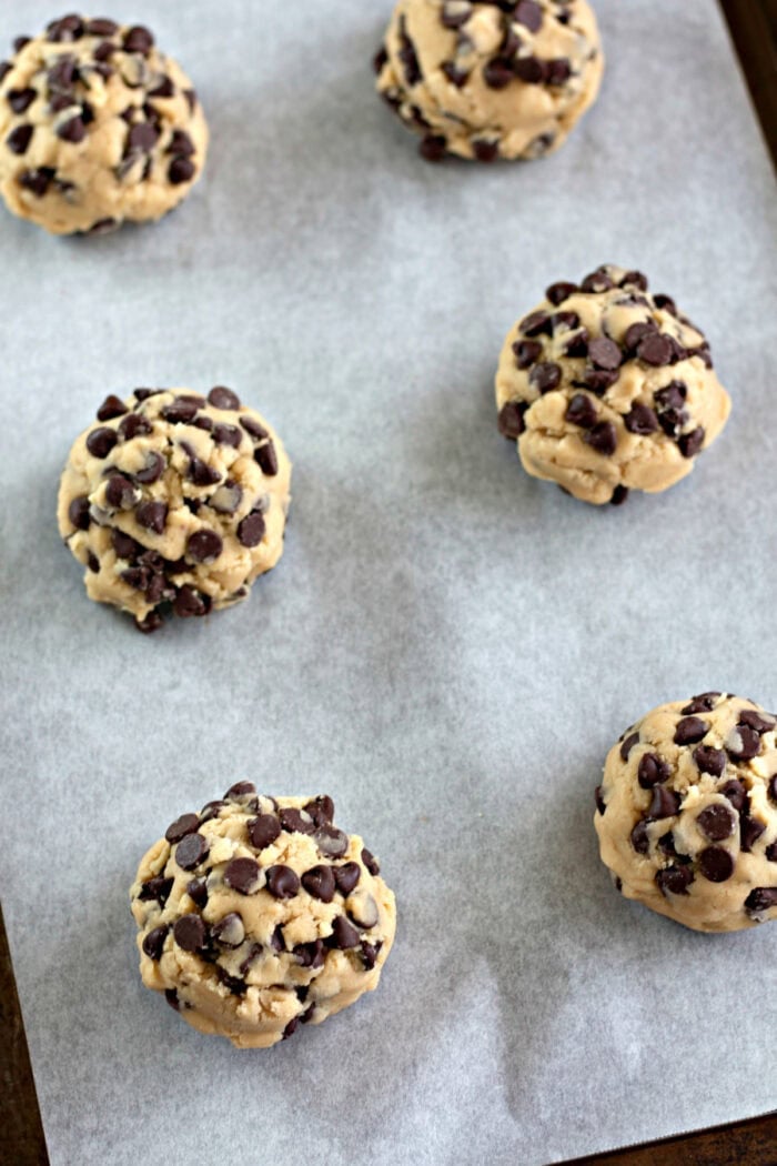 chocolate chip cookie dough balls on a baking sheet