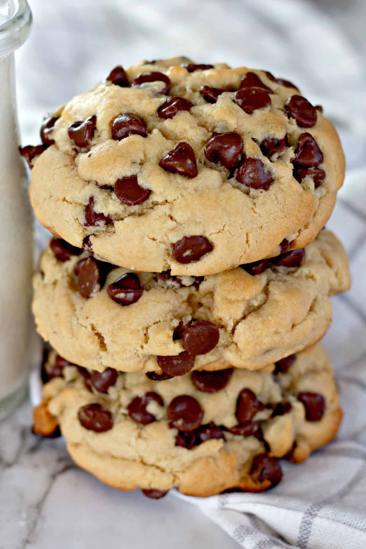 These Thick Chocolate Chip Cookies are giant and loaded with chocolate chips, just like you would buy at a your favorite bakery or cafe. stacked Thick Chocolate Chip Cookies