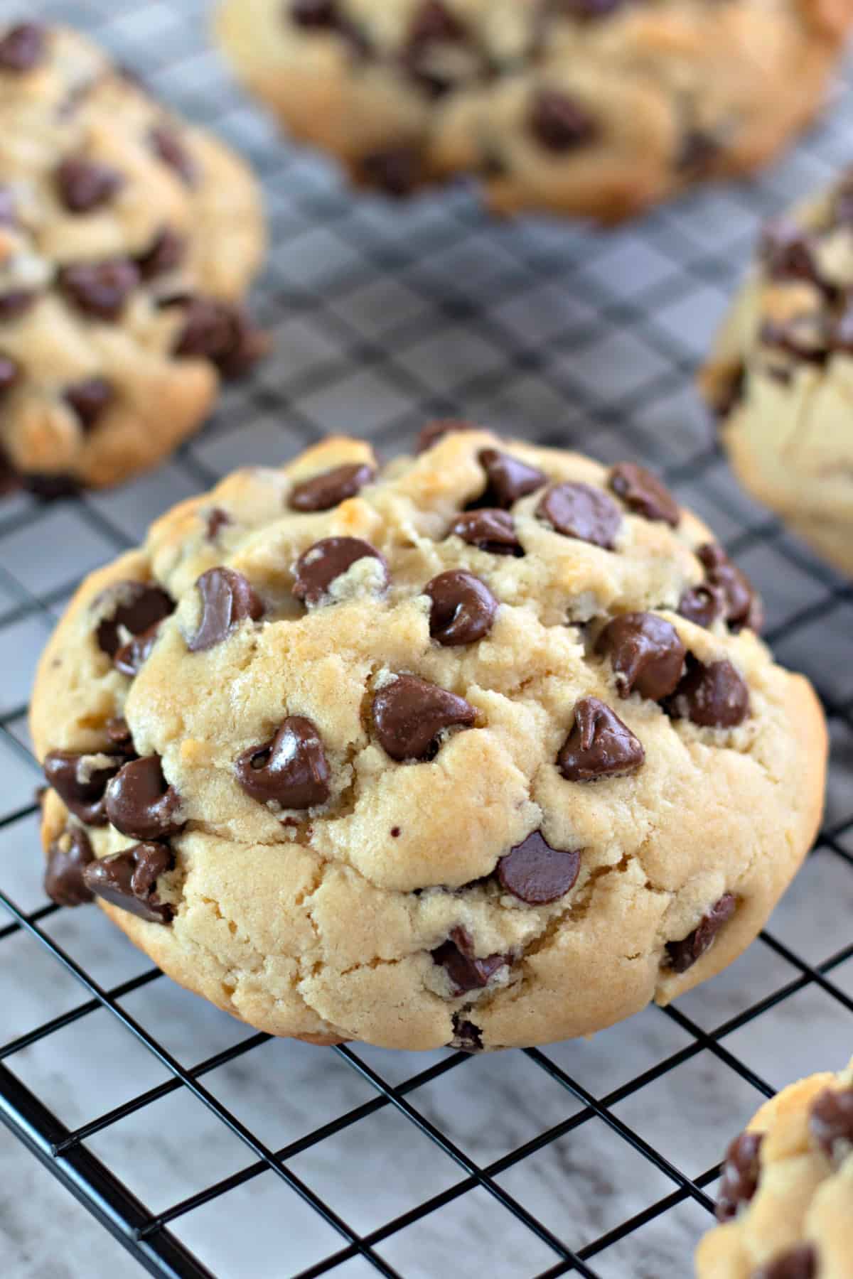 Baked thick chocolate chip cookies on a cooling rack