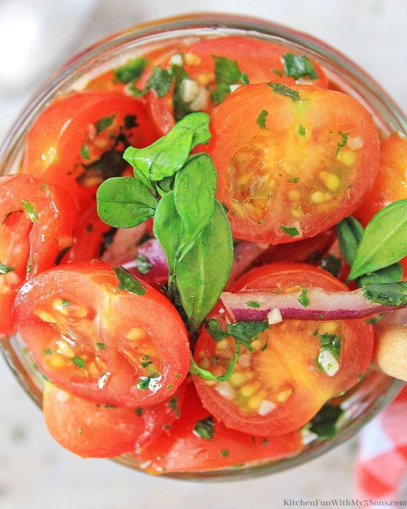 overhead picture of marinated tomatoes in a jar