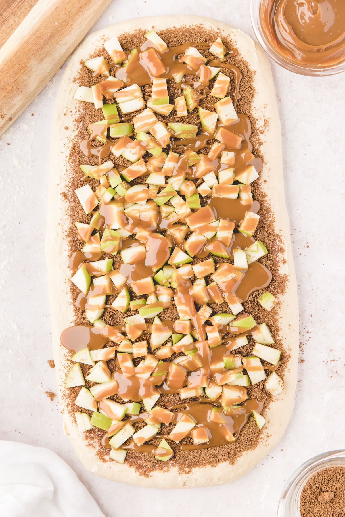 chopped apples and caramel over dough