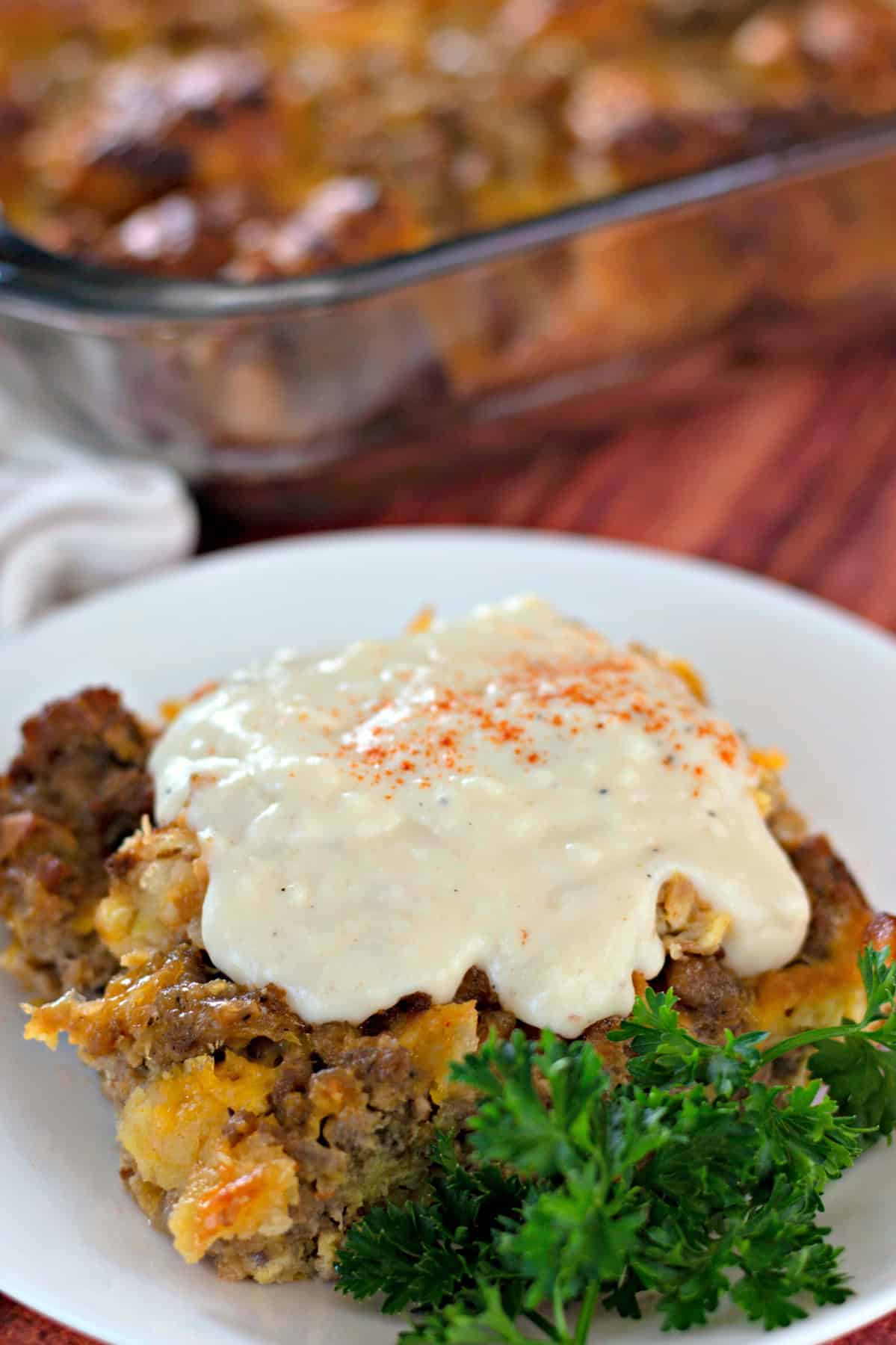 A serving of croissant breakfast casserole topped with gravy