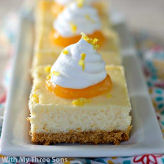 Lemon Cheesecake Bars on a plate with lemon curd garnish.