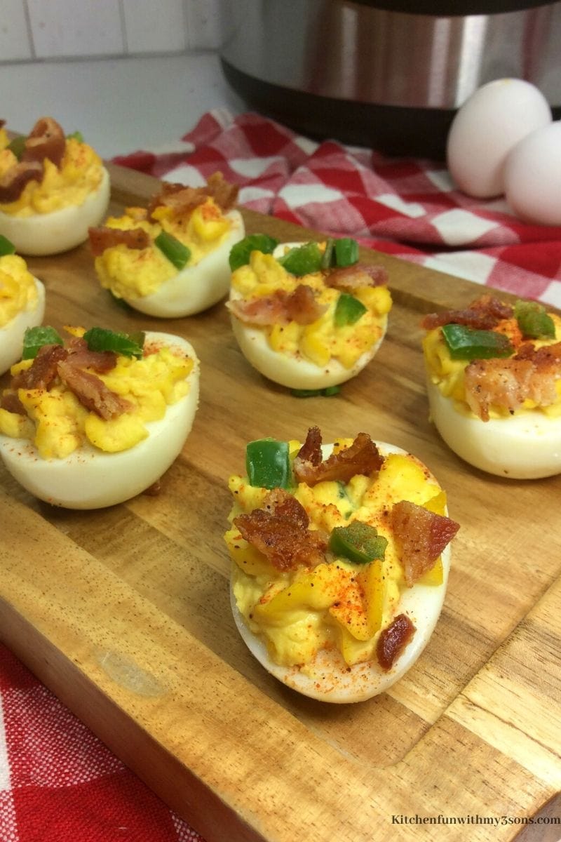 jalapeno bacon deviled eggs in a cutting board