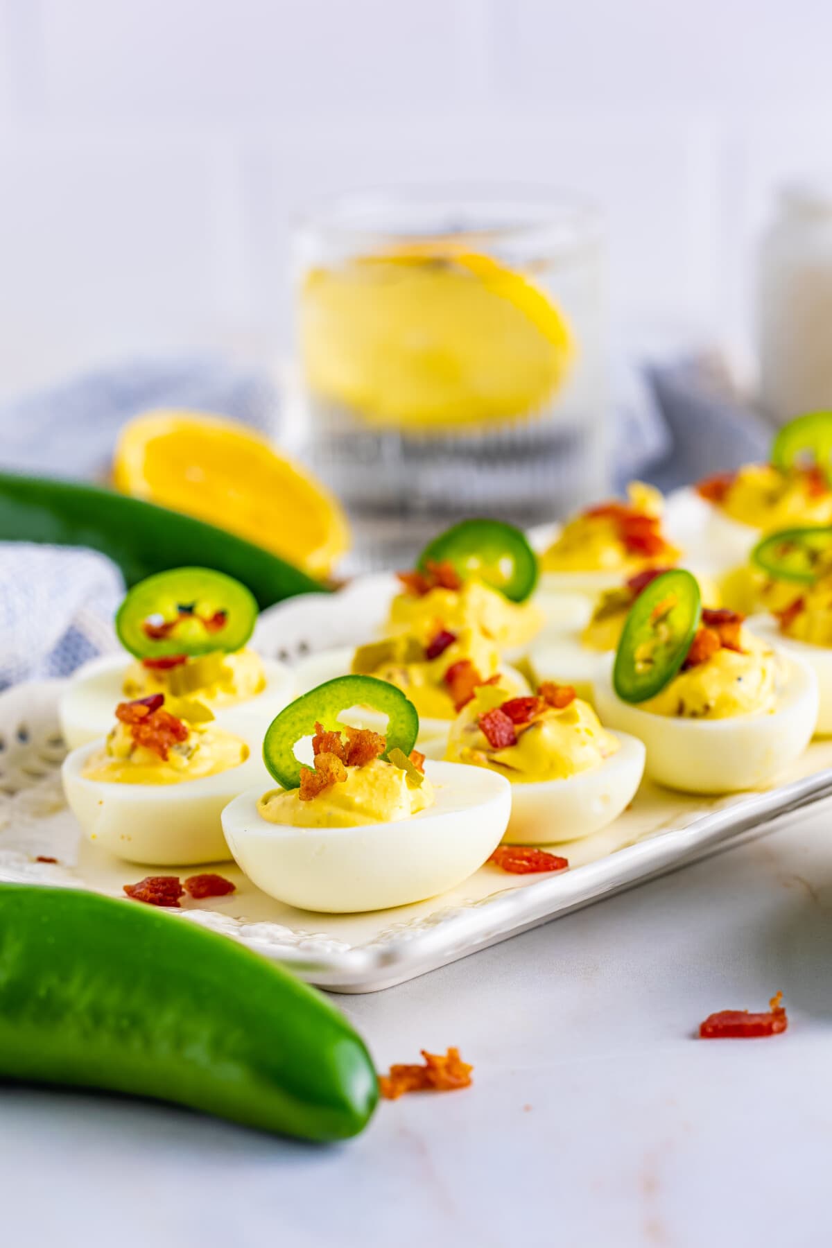 Jalapeno Deviled Eggs on a white table.