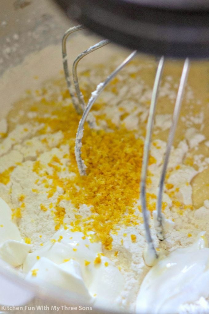 mixing together the cake batter with lemon zest