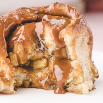 Caramel Apple Cinnamon Roll with a bite taken out of it.
