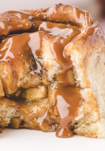 Caramel Apple Cinnamon Roll with a bite taken out of it.