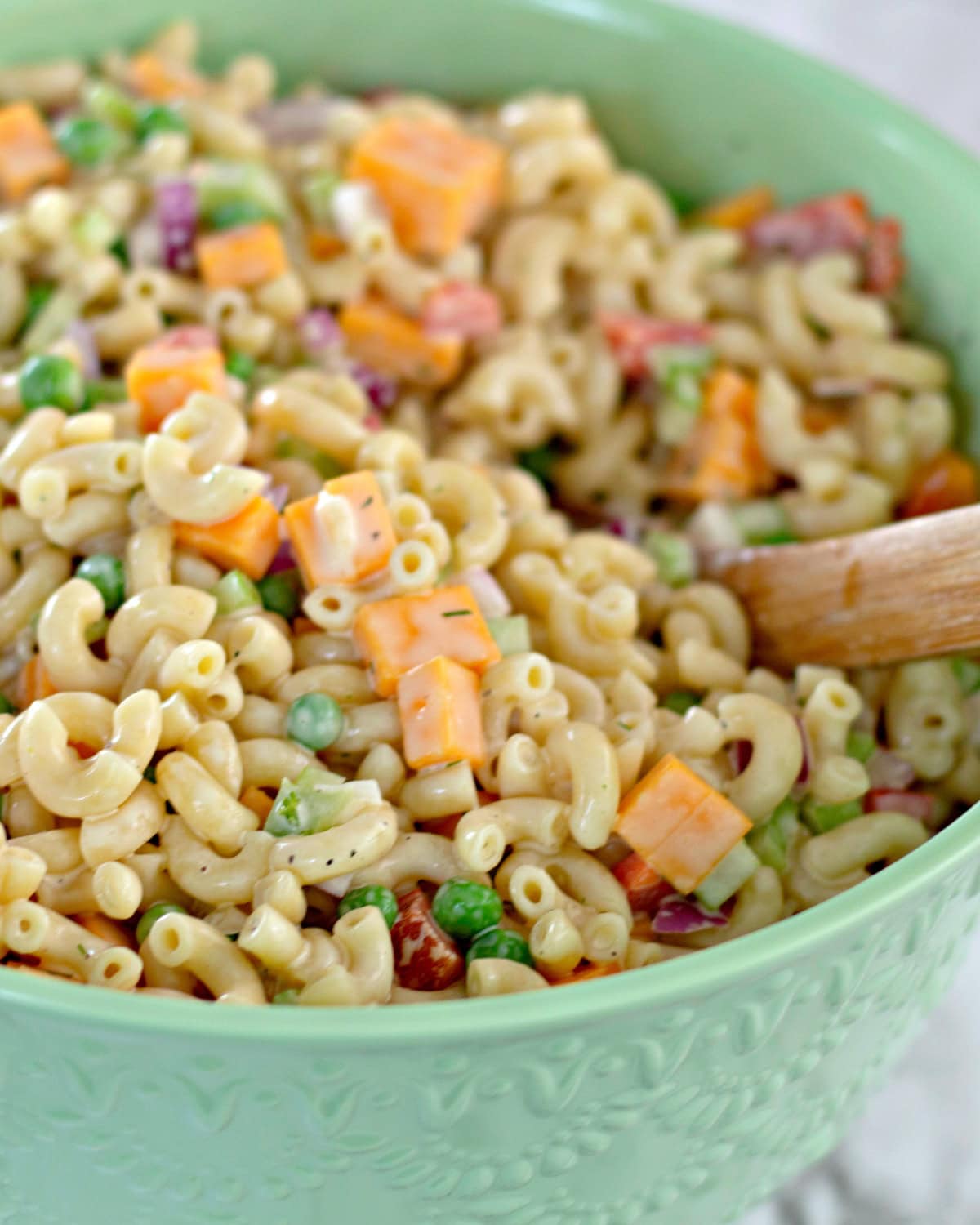 Macaroni Salad in a bowl with a wooden spoon