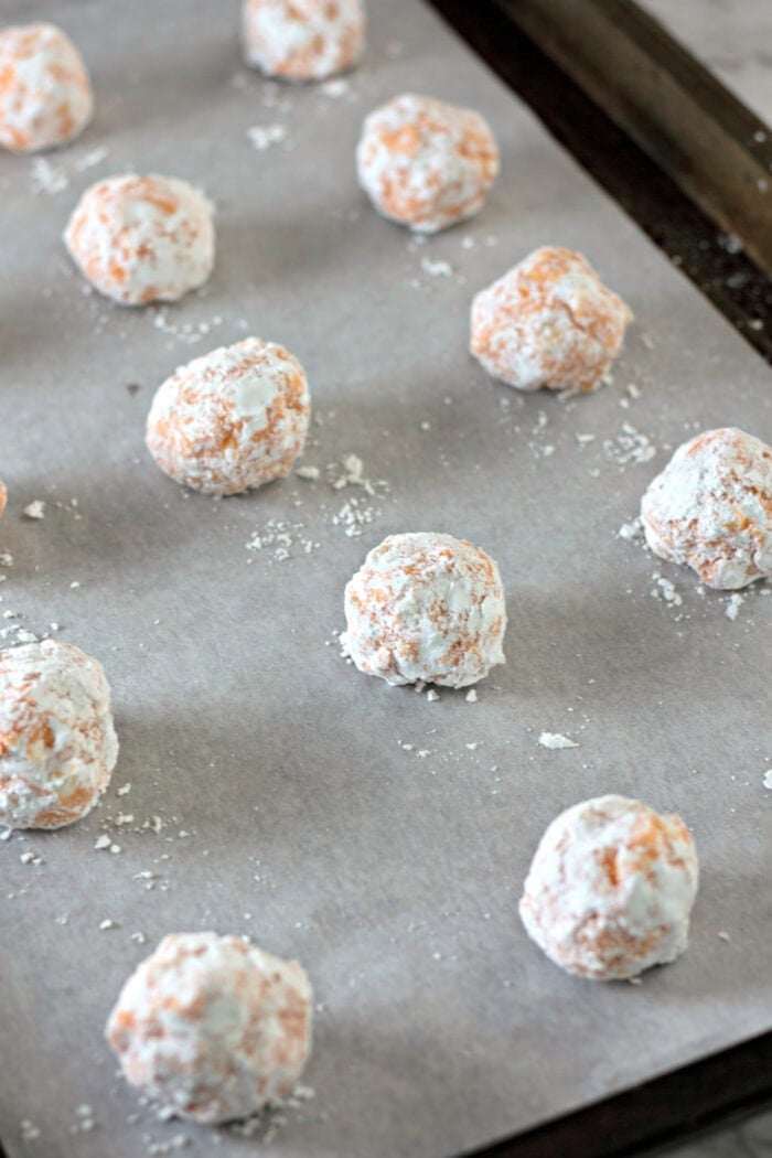 cookie dough balls on a baking sheet