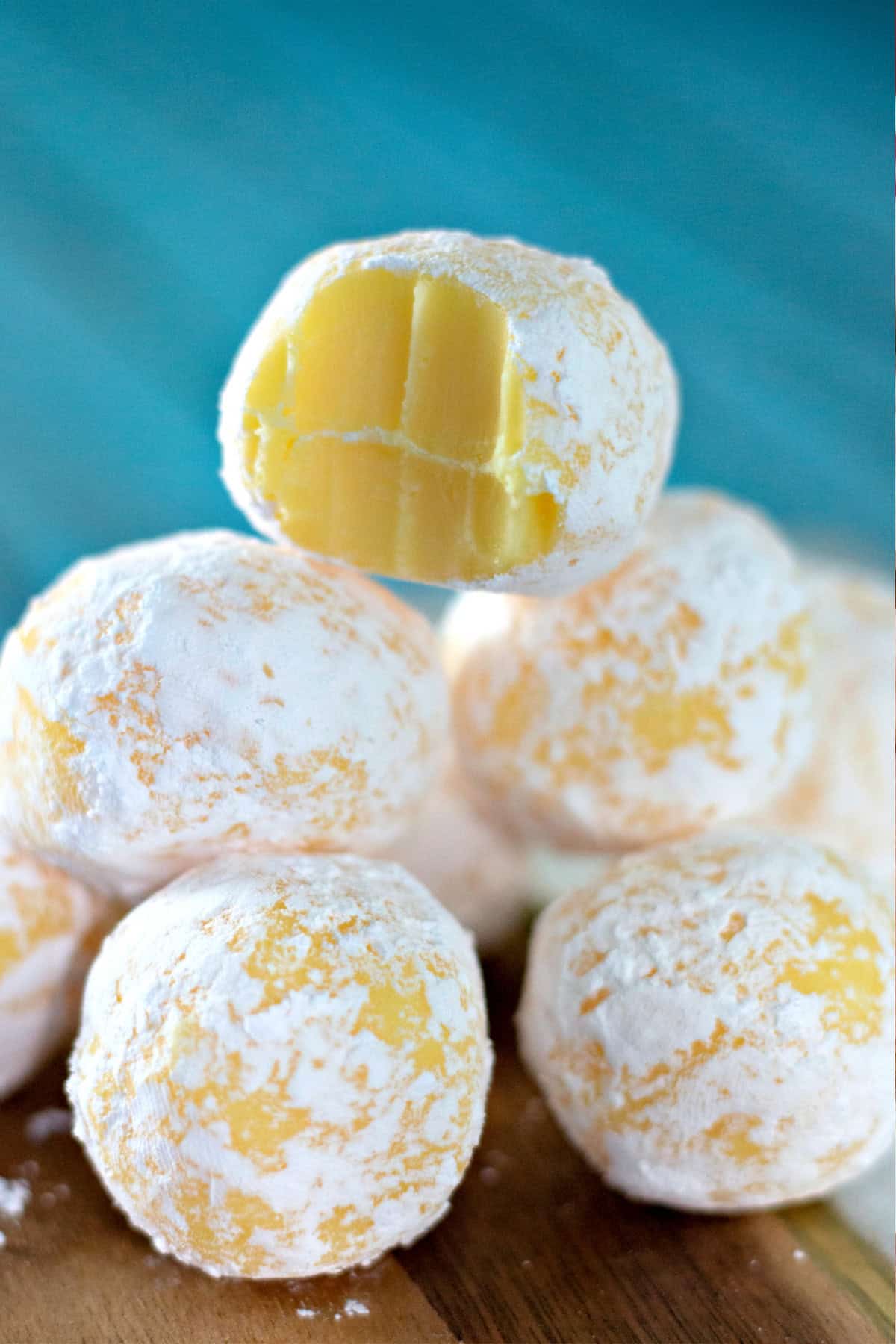These Lemon Truffles are a super easy no bake treat made with a creamy white chocolate ganache flavored with a burst of lemon. stacked White Chocolate Lemon Truffles