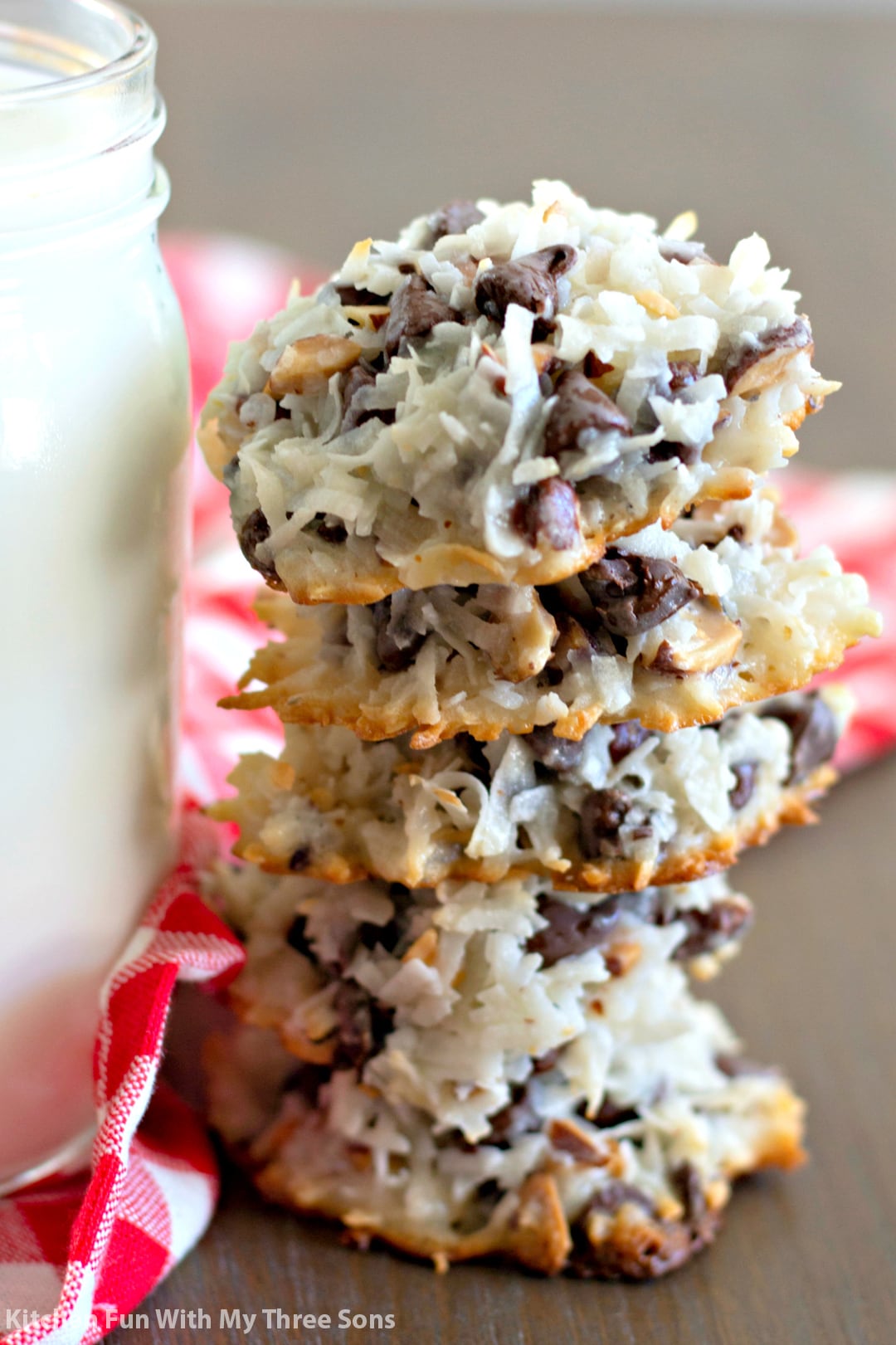 Almond Joy Cookies stacked next to a glass of milk