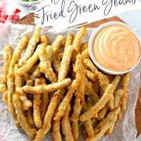 Beer Battered Fried Green Beans on a plate with sriracha dip.