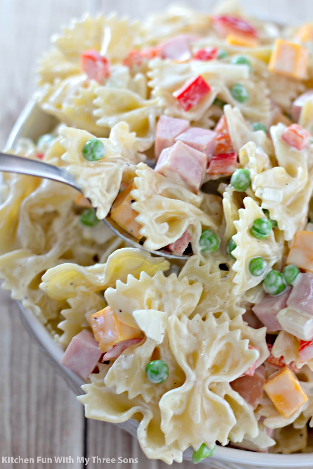 scooping out a serving of Bowtie Pasta Salad Recipe