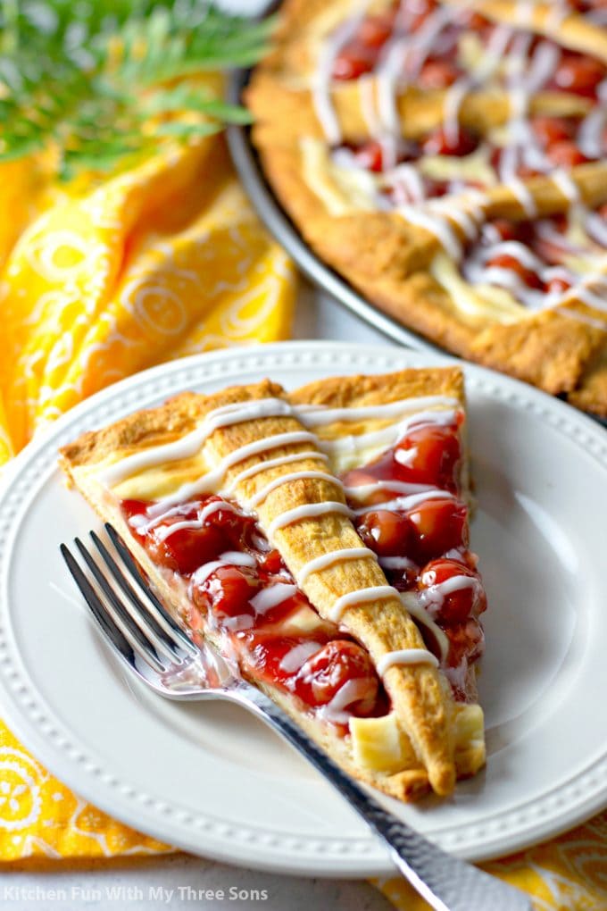 Cherry Cheese Crescent Ring on a white plate with a yellow napkin