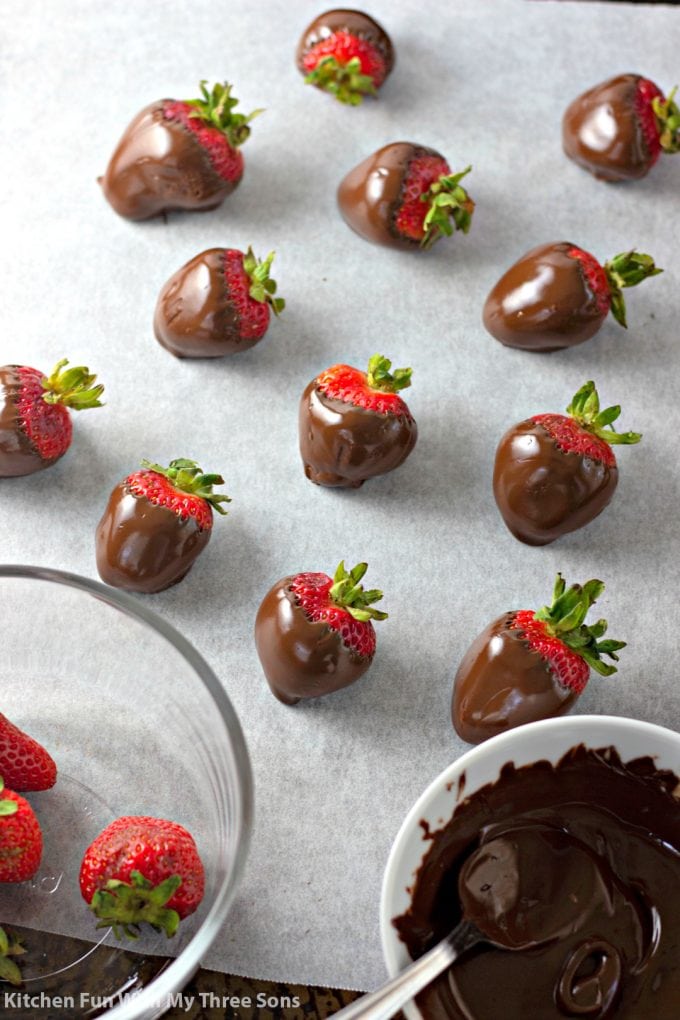 dipping strawberries into melted semi sweet chocolate