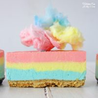 Cotton Candy Cheesecake recipe with a crunchy graham cracker crust then has layers of fun, colorful cheesecake in blue, yellow and pink.