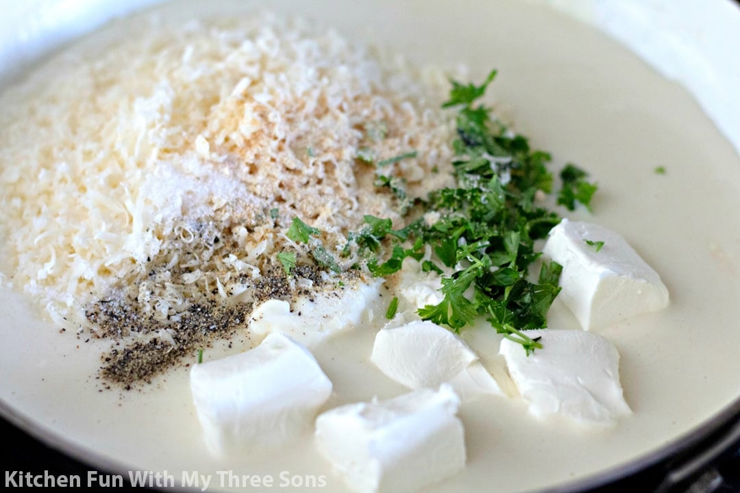 milk, butter, flour, parmesan cheese, cream cheese, parsley, and seasonings in a pan.
